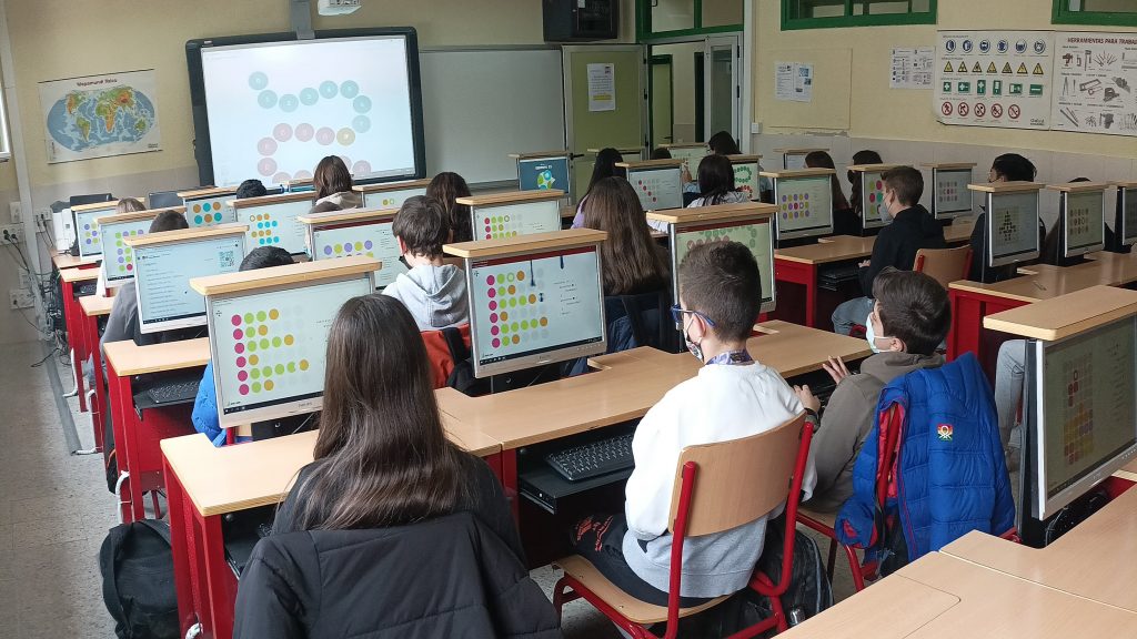 Alumnado en una clase multimedia. Cada alumno/a posee su propio ordenador y realizan una tarea colectiva.
